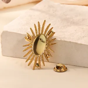 Detailed back view of gold starburst brooch showing the sharp pin and metal clutch clasp