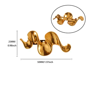 Detail view of wavy gold-tone brooch showing 50mm width and 25mm height dimensions