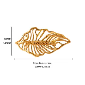 Macro detail of golden monstera leaf brooch showing hollow design and 57mm dimensions