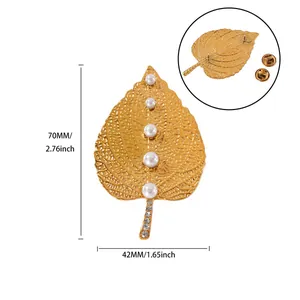Detailed size view of golden leaf brooch with white pearls and sparkling rhinestones