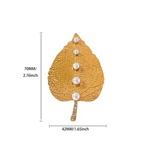 Detail view of golden leaf brooch with white pearls and small diamonds, size 70x42mm