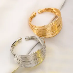 Layered gold and silver minimalist wire open cuff bracelets with spherical ends set