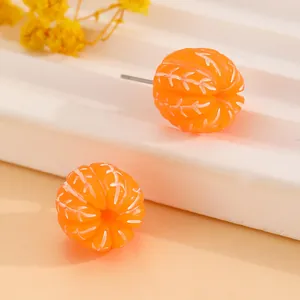 Close-up of realistic orange segment resin stud earrings with silver metal posts