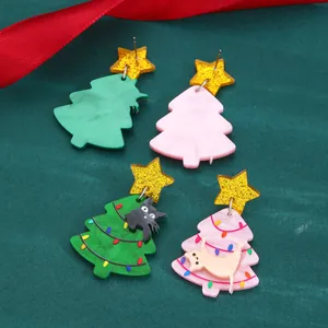 Detail of Christmas tree acrylic earrings with star studs and cute cat patterns