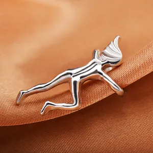 Silver silhouette climber ear cuff for women on an orange silk satin fabric background