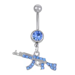 Macro shot of silver AK-47 rifle belly ring with inlaid light blue crystals and barbell