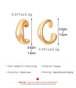 Detalle de los ear cuffs dorados en forma de C hechos de cobre pulido con medidas