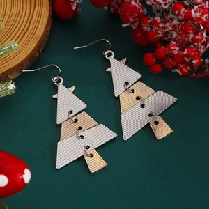 Detail of Christmas tree drop earrings with gold and silver alloy texture and festive decor