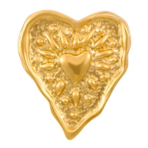 Close-up of gold heart ring with vintage lava texture and sunburst relief detail