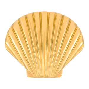 Macro detail of golden scallop shell ring featuring textured radial pattern and metallic shine