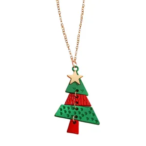 Detail showing green and red Christmas tree pendant necklace with a golden star charm
