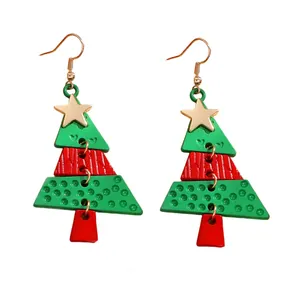 Close-up of alloy Christmas tree earrings with gold stars and red green tiered pendants