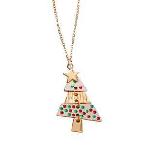 Close-up of a gold Christmas tree pendant with colorful enamel dots and a gold star