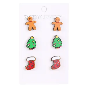 Detail view of wooden Christmas stud earring set with gingerbread man and festive tree