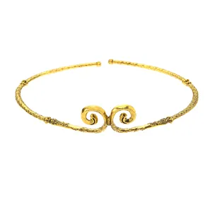 Detail of vintage gold-plated neck collar featuring cloud relief patterns and hammered texture