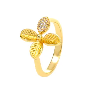 Golden ginkgo leaf ring with sparkling crystals and polished metallic finish