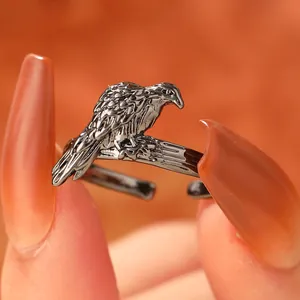 Macro shot of vintage dark silver eagle ring showing detailed feather texture and open band