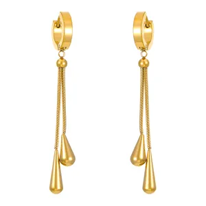 Elegant gold drop earrings set with long tassels and teardrop pendants in minimalist style