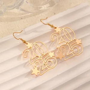 Detailed view of 2025 numeric gold-plated drop earrings with star accents for New Year
