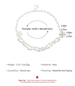 Detail view of pearl choker with two camellia flowers and 48cm adjustable length
