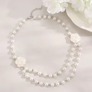 Elegant pearl choker featuring 3D camellia flowers and a layered necklace design
