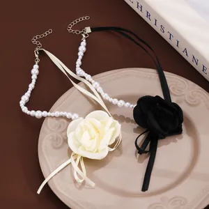 Detail of satin rose chokers with faux pearls and adjustable lobster clasps