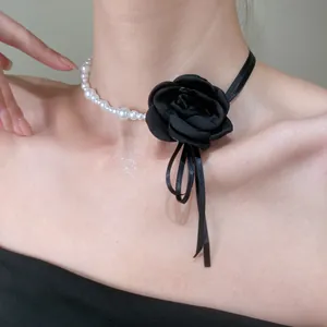 Detail of Y2K choker featuring white pearls, black ribbon, and a fabric leopard rose flower