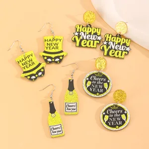 Detailed close-up of festive Happy New Year acrylic earrings with gold glitter stars