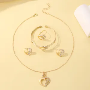 Detailed view of golden jewelry set featuring heart designs with sparkling crystal accents