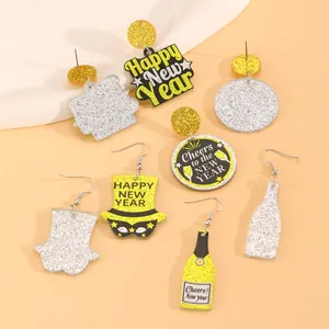 Detail of 2025 New Year earrings with glitter acrylic stars and champagne bottle designs