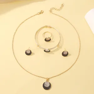 Detailed macro view of luxury gold jewelry set including necklace, bracelet, ring, and earrings