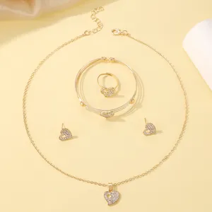 Detailed close-up of golden heart-shaped jewelry set with necklace and sparkling crystals