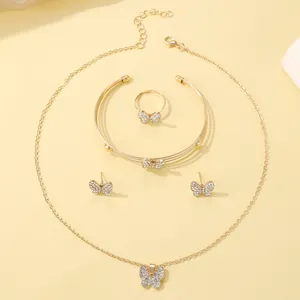 Detailed set of gold butterfly jewelry with sparkling crystals including necklace and ring