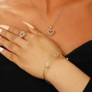 Close-up of elegant hollow heart jewelry set with sparkling stones on model