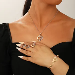 Detail view of heart-shaped gold jewelry set with zircon pave on a female model
