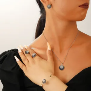 Close-up of elegant four-piece jewelry set with black and white zircon pavé circles