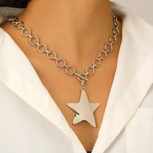 Gothic silver fluid star pendant necklace with OT toggle clasp on a female model