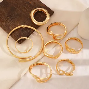 Set of gold-plated chunky bangles and collar featuring irregular organic and hollow designs