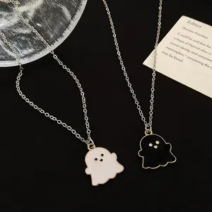 Close-up of black and white cartoon ghost necklaces with colorful enamel drip finish