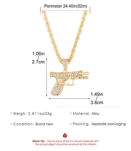 Detailed view of gold AK gun pendant with iced out rhinestones and size measurements
