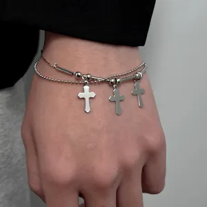 Double-layered silver bracelet with cross pendants in a minimalist Y2K aesthetic