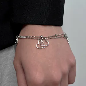 Y2K style double-layered beaded silver bracelet with interlocking hollow heart charms