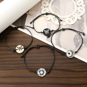 Detail von verstellbaren geflochtenen Armbändern mit Sonnen-, Mond- und Schmetterlingsanhängern