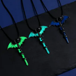 Detailed view of three dragon and sword luminous necklaces glowing in blue and green