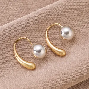 Elegant gold and silver two-tone teardrop metal earrings with mirror finish spheres