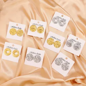 Eight pairs of textured stainless steel earrings with matte and hammered finish in gold and silver