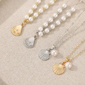 Vintage shell pearl necklace set with crystals in gold and silver on linen background
