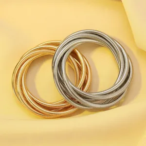 Exaggerated spring jewelry set with gold and silver coiled necklaces and bracelets