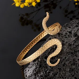 Close-up of golden octopus tentacle arm cuff featuring detailed suction cup textures