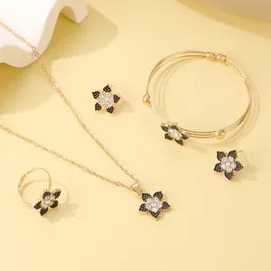 Detailed set of black enamel flower necklace, bracelet, ring, and earrings with crystals